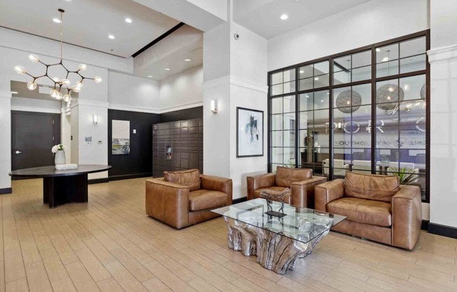 a large lobby with leather couches and a glass table