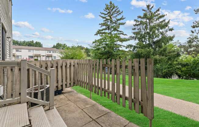 the view from the back deck of a house with a wooden fence