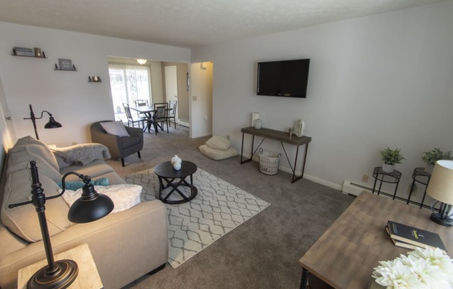 This is a photo of the living room in the 740 square foot 1 bedroom model apartment at Compton Lake Apartments in Mt. Healthy, OH.