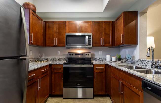 A kitchen with wooden cabinets and stainless steel appliances.