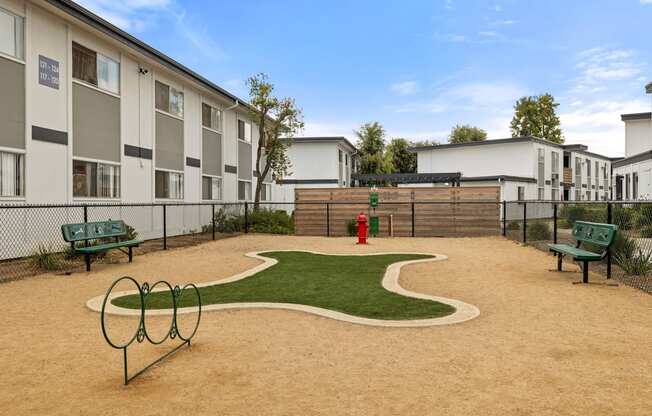 A playground area with a slide, swings, and a sandbox.