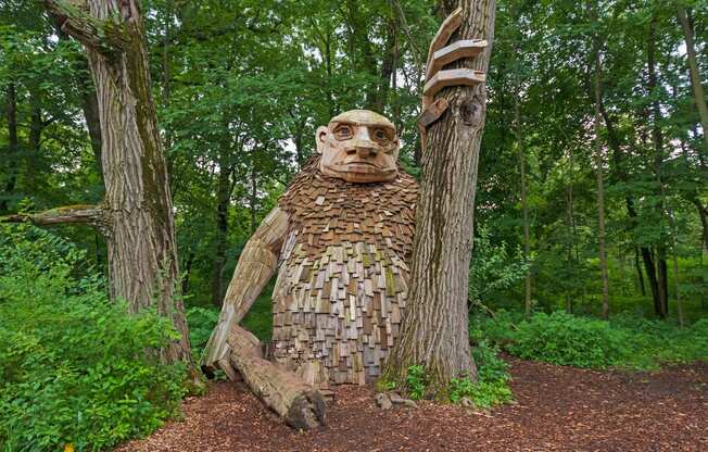 a statue of a man in the woods