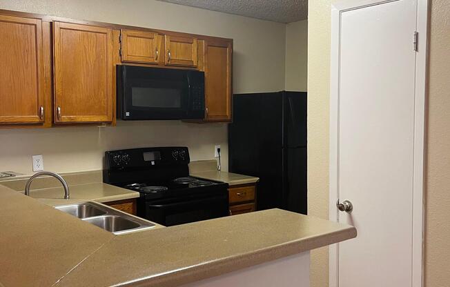 a kitchen with a sink and a microwave