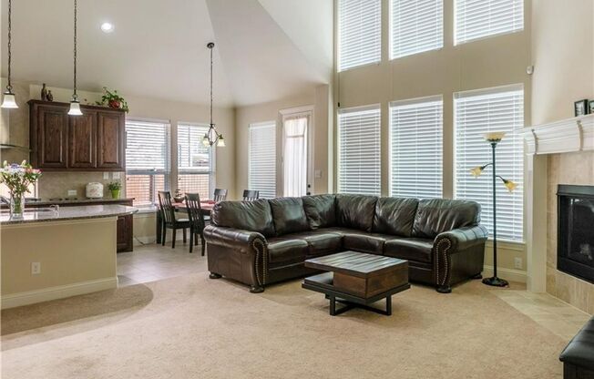 Grand entry, Open floor plan with high ceiling, Spacious rooms, Elegant kitchen featuring stainless steel appliances.