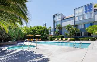 a swimming pool with a building in the background