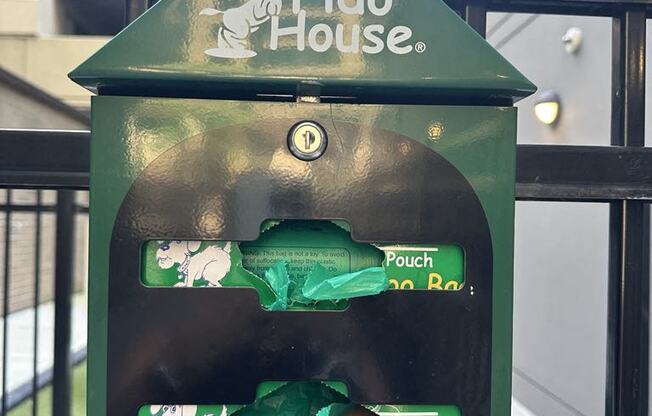 a bird house with a green bird figurine in it