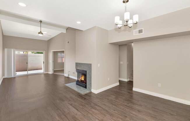 the living room has a fireplace and hardwood floors