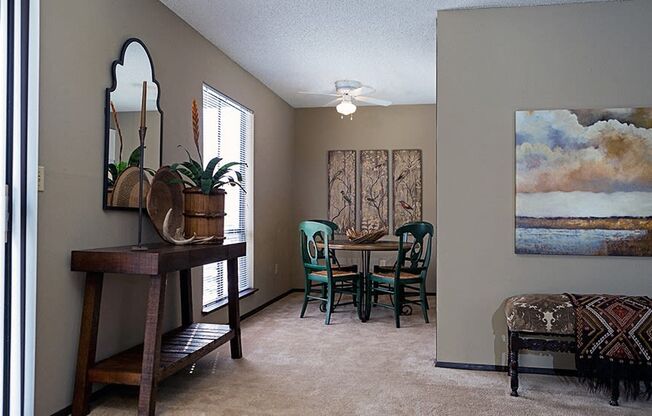 an empty living room with a dining room table and chairs