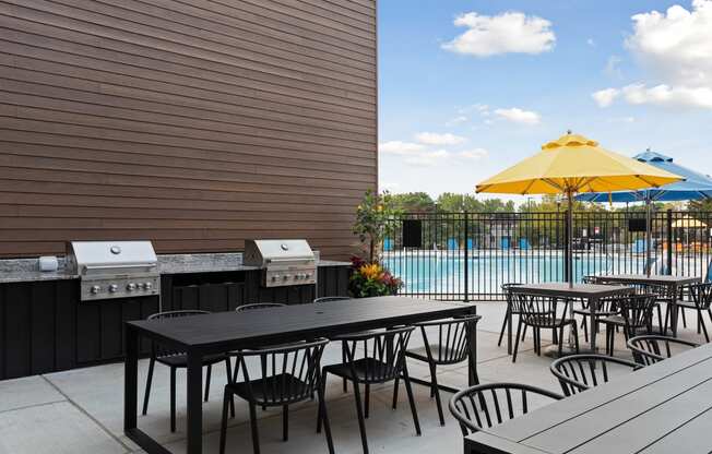 Poolside tables at Villages on McKnight Apartments