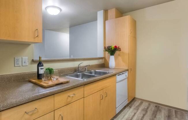 A kitchen with wooden cabinets and a granite countertop.