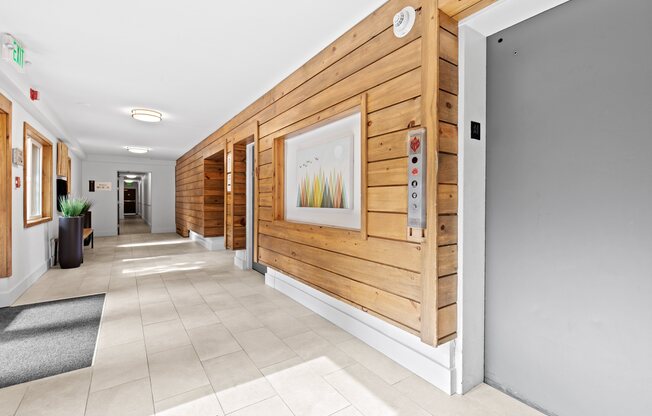 a hallway with wood paneling and a painting on the wall