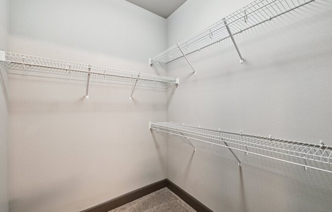 Empty white shelves in a room.