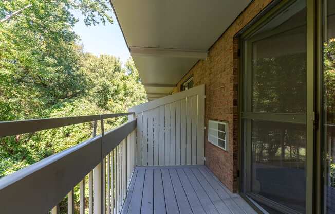 a balcony with a view of trees and a deck