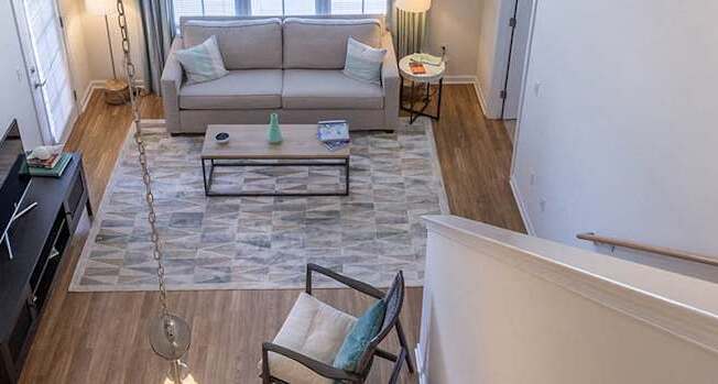 A living room with a grey couch and a coffee table.
