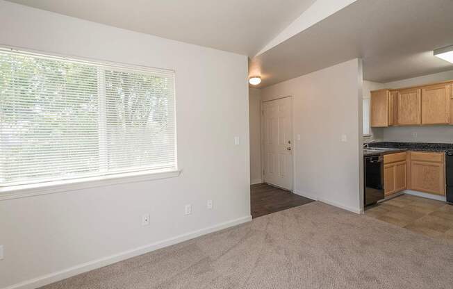 A room with a window and a door leading to a kitchen at Autumn Oaks Apartments, Roseville, CA, 95678