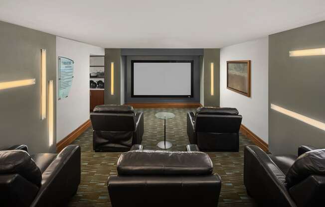 a living room with leather chairs and a projector screen