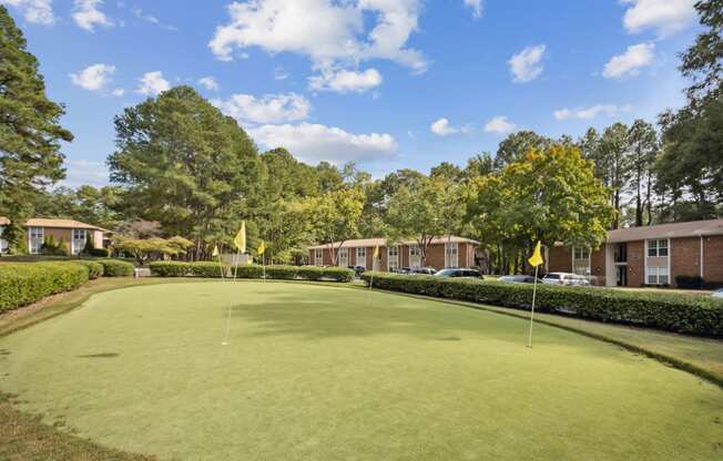 a putting green with apartments in the background at Shellbrook, Raleigh, NC