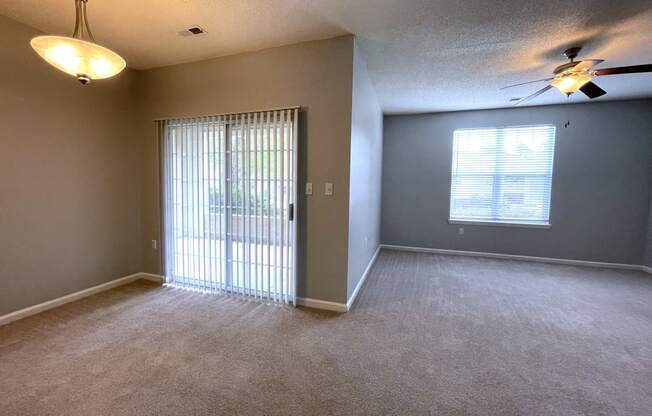 Living room with a window and a ceiling fan at The Chase, Burlington