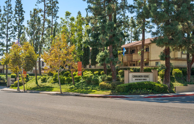 a building with a street in front of it and trees
