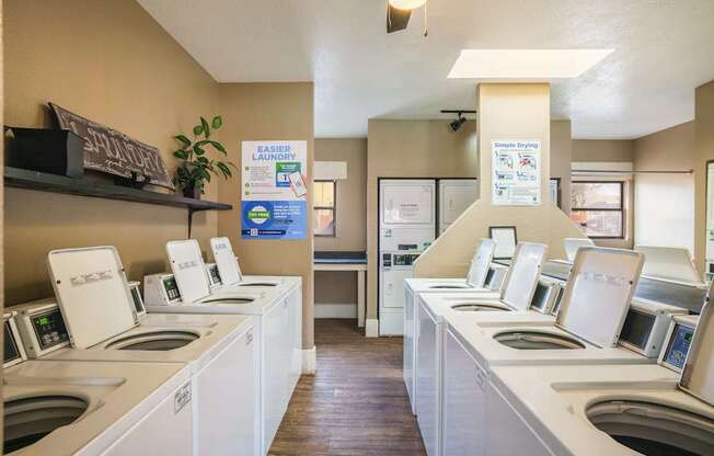 A laundromat with rows of washers and dryers.