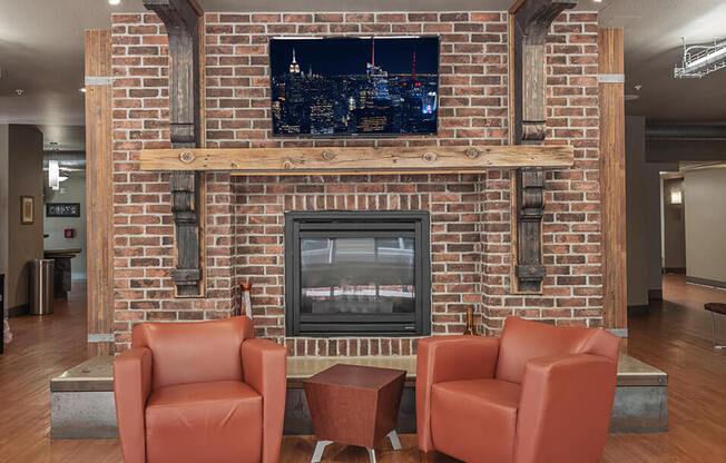 a rec room with a fireplace and chairs