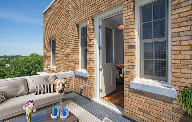 a balcony with a couch and a table