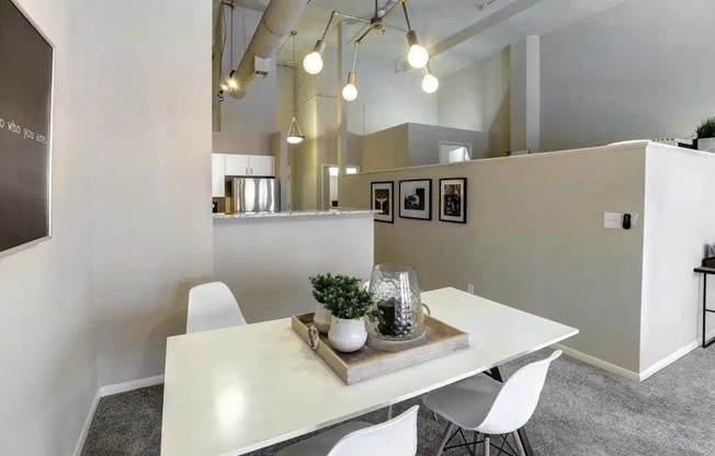 a dining room with a white table and chairs