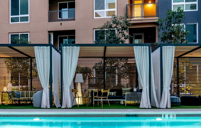 A pool area with a building in the background.