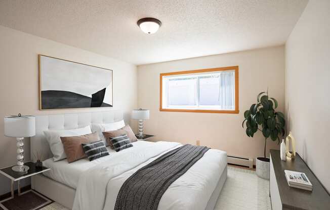 a bedroom with a large bed and a window. Fargo, ND Hawn Apartments