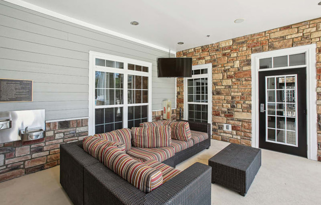 a living room with a couch and a brick wall