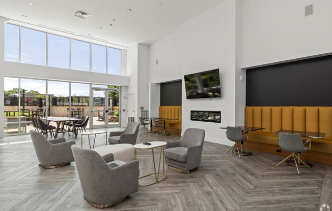 a living room with chairs and a table and a television