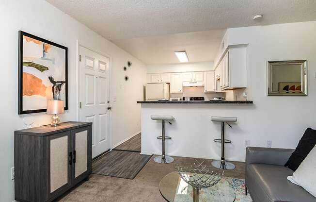 a living room with a bar and a kitchen