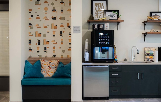 A kitchen with a blue couch and a wall with a pattern of shapes.