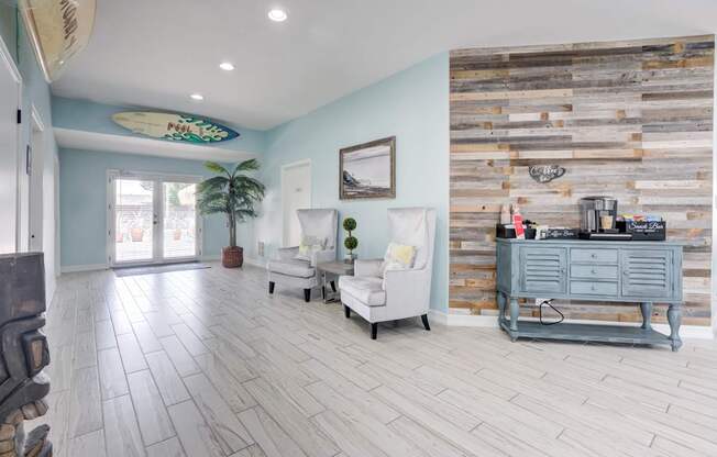 A living room with a white couch and a wooden wall.