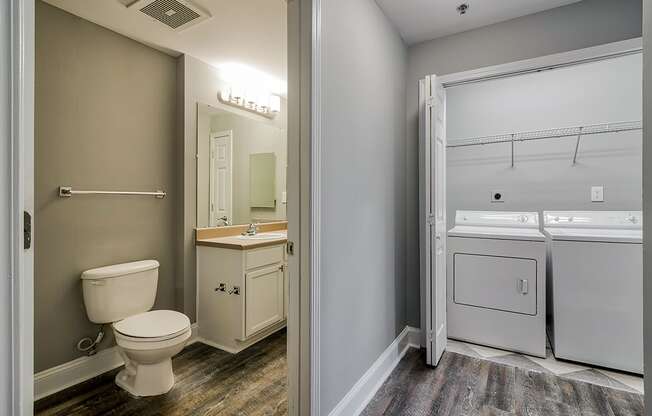 a bathroom with a toilet and a washer and dryer