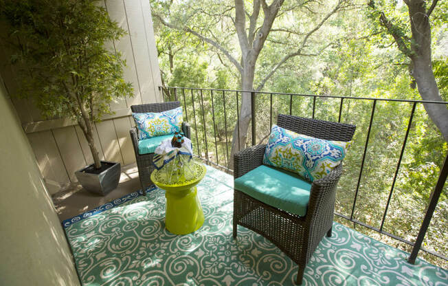 Model Apartment patio with wicker chairs and a table