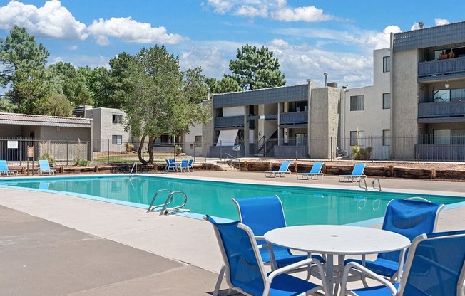 our apartments offer a swimming pool with chairs and a table