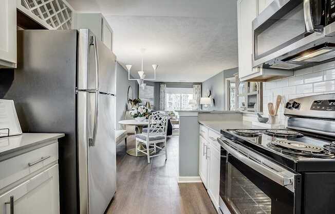 A kitchen with a black refrigerator and stove.