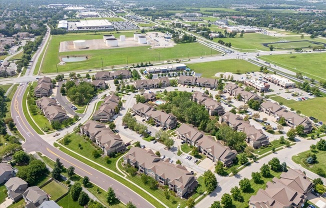 A suburban neighborhood with houses and a large open field.