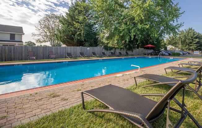 a couple of lawn chairs sitting on top of a body of water