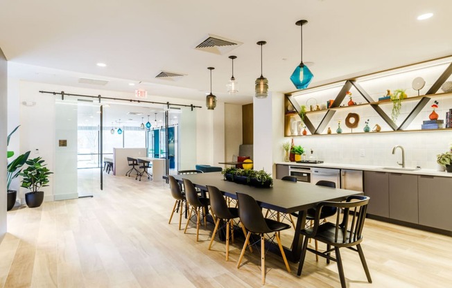 a dining room and kitchen with a table and chairs at One Ten Apartments, New Jersey
