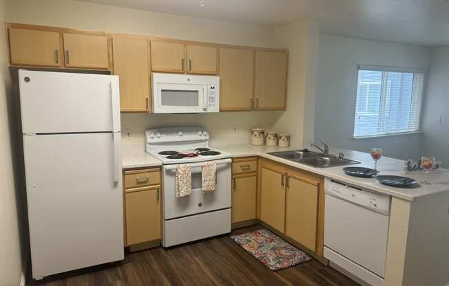 a kitchen with white appliances and wooden cabinets