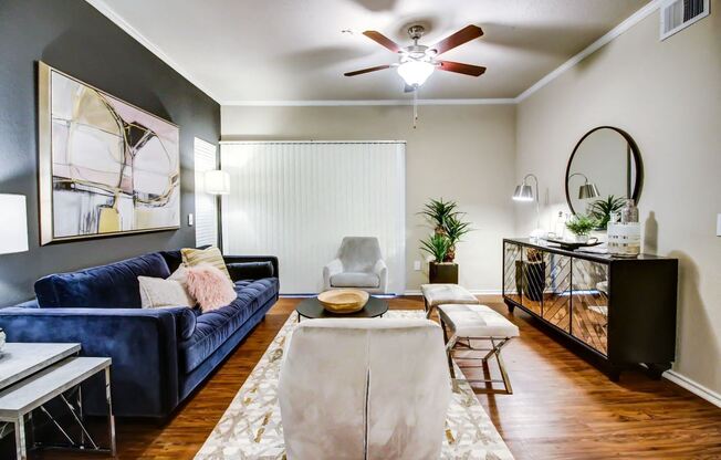 Gorgeous living room with hardwood style flooring, crown molding and ceiling fan