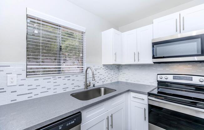 Stainless steel appliances with glass top stove in kitchen at Sunset Hills