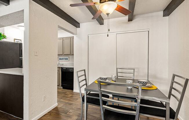 a dining room with a table and chairs and a ceiling fan