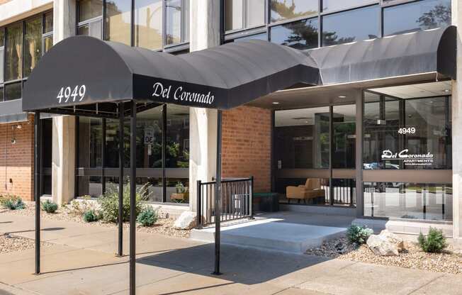 the front of a building with a black awning