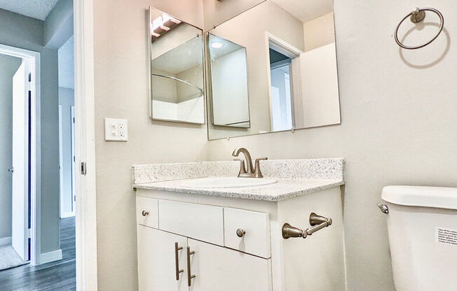 a bathroom with a sink and a mirrorat The Arches Apartments, LLC, California