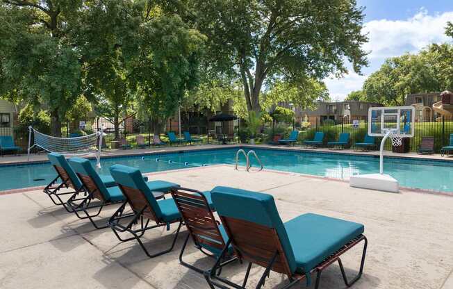 A pool with chairs around it.