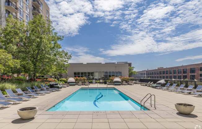 a swimming pool at a hotel with chairs around it