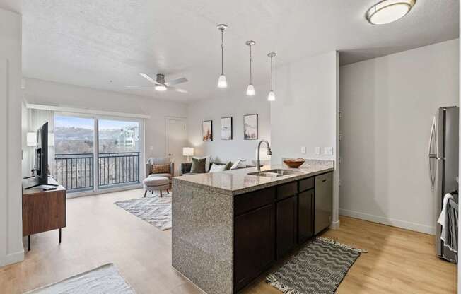 A modern kitchen with a large island and a view of the city. at Wilmington Flats Apartments, Salt Lake City